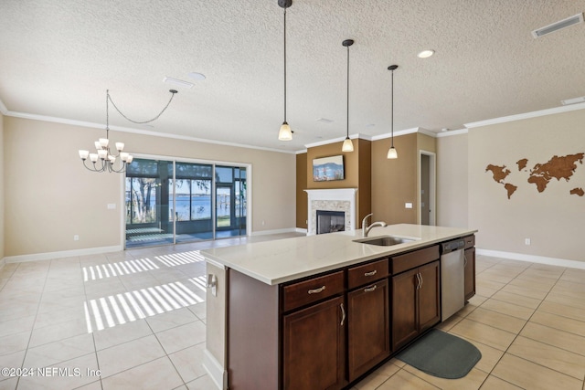 kitchen with stainless steel dishwasher, ornamental molding, sink, a center island with sink, and hanging light fixtures