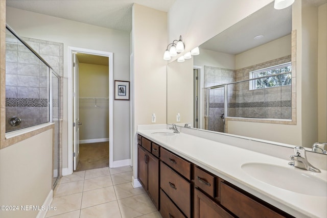 bathroom featuring tile patterned floors, vanity, and an enclosed shower