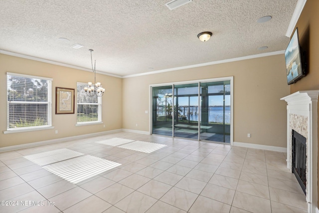 interior space featuring crown molding, light tile patterned floors, a textured ceiling, and an inviting chandelier