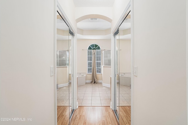 hallway with light hardwood / wood-style flooring