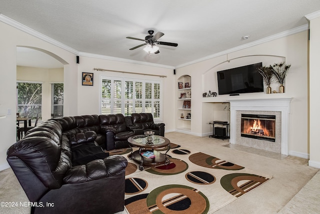 tiled living room featuring plenty of natural light, built in features, and crown molding