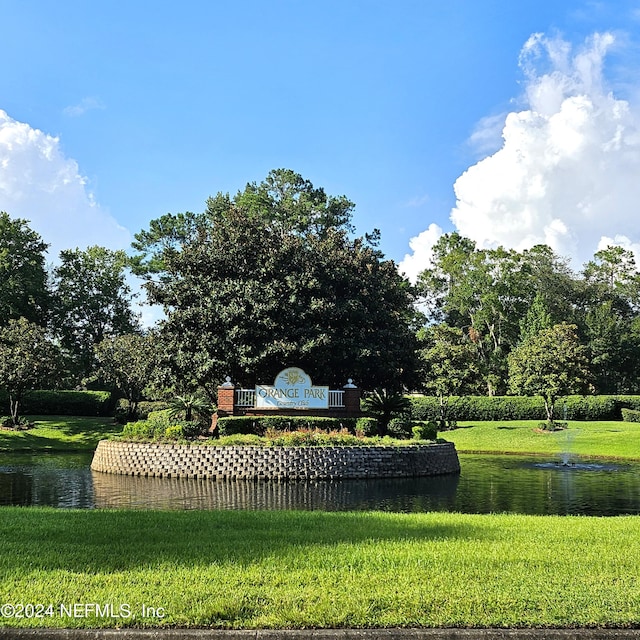 view of community with a lawn and a water view