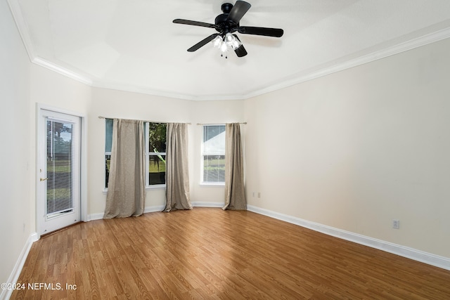 empty room with crown molding, ceiling fan, and hardwood / wood-style flooring