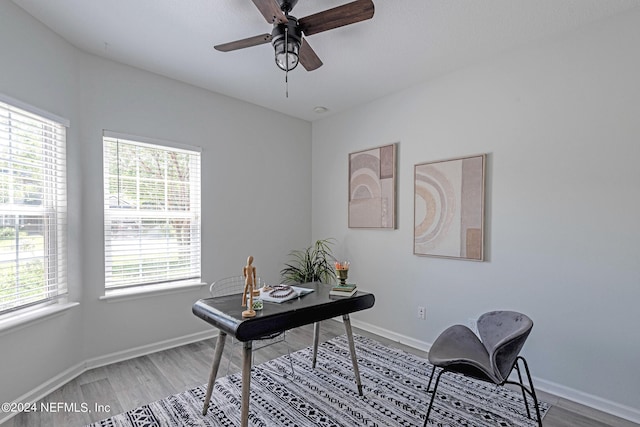 home office with hardwood / wood-style flooring and ceiling fan