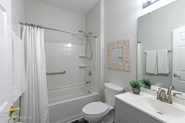 full bathroom featuring toilet, vanity, and shower / tub combo with curtain