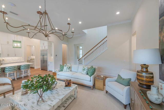 living area featuring stairs, ornamental molding, and baseboards