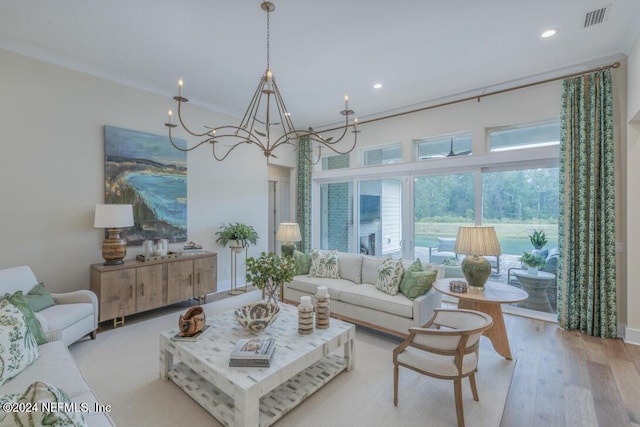 living area featuring recessed lighting, a notable chandelier, wood finished floors, visible vents, and crown molding