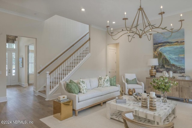 living room featuring crown molding, stairs, baseboards, and wood finished floors