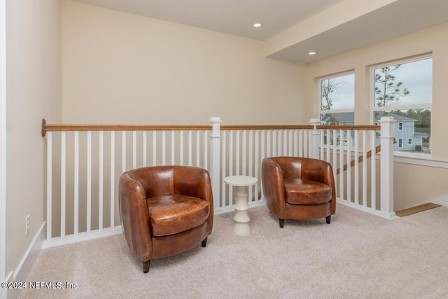 living area featuring carpet floors, recessed lighting, and an upstairs landing