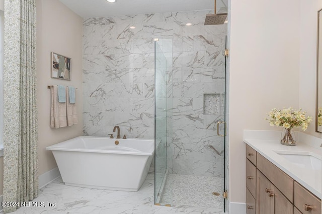 full bathroom featuring a marble finish shower, baseboards, marble finish floor, a freestanding bath, and vanity