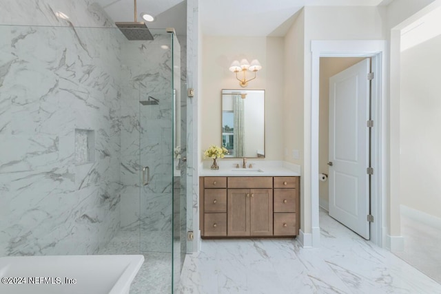 bathroom with a marble finish shower, marble finish floor, a freestanding bath, vanity, and recessed lighting