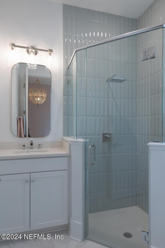 bathroom featuring a stall shower and vanity