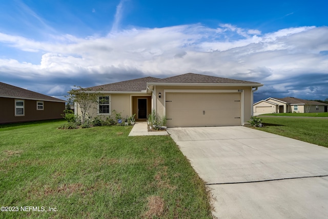 view of front of property featuring a garage and a front yard