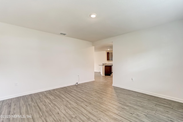 spare room featuring light hardwood / wood-style flooring