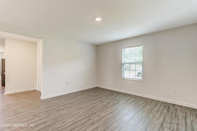 spare room with light hardwood / wood-style floors