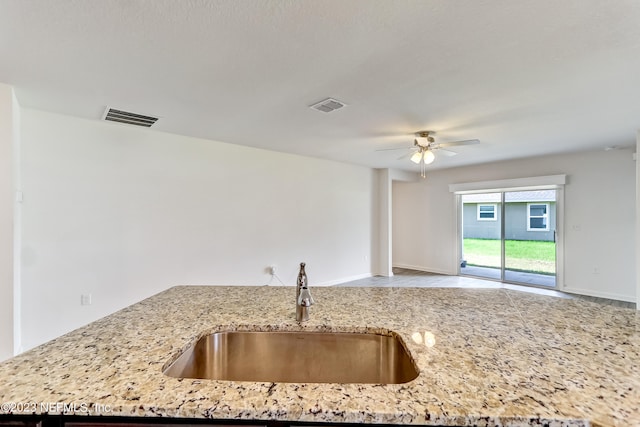 kitchen with ceiling fan and sink