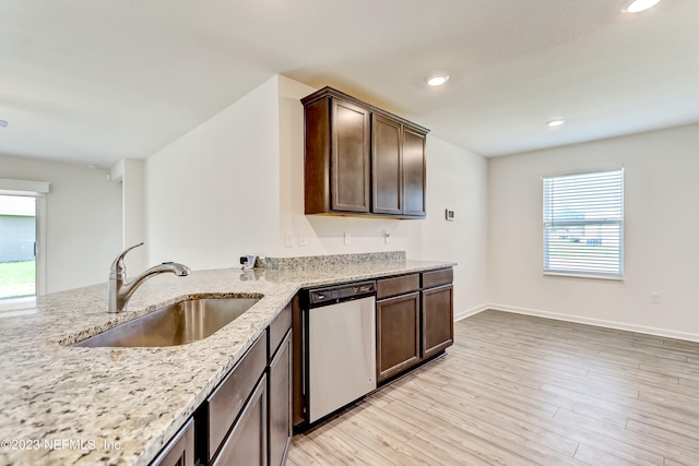 kitchen with dishwasher, sink, dark brown cabinets, light hardwood / wood-style floors, and light stone counters