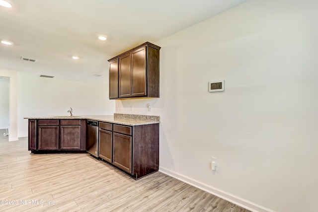 kitchen with kitchen peninsula, dark brown cabinets, and light hardwood / wood-style floors