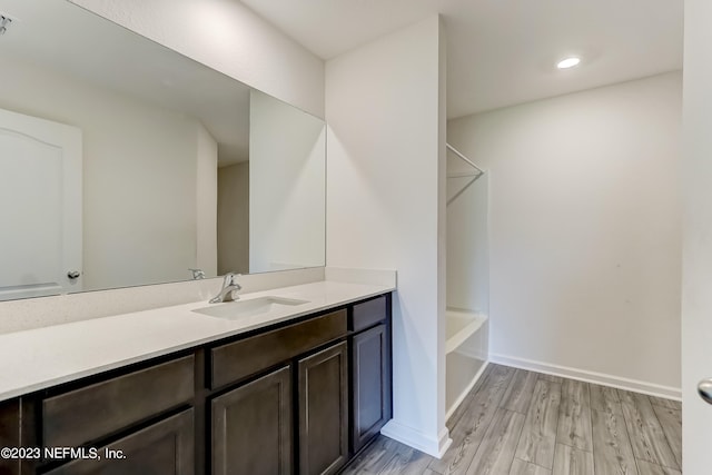 bathroom with shower / bathing tub combination, vanity, and wood-type flooring