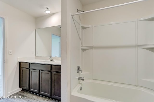 bathroom featuring hardwood / wood-style floors, vanity, and  shower combination