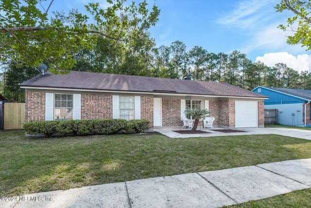 ranch-style home with a garage and a front lawn