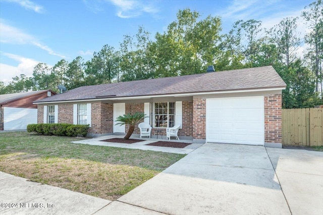 ranch-style home with a garage and a front lawn