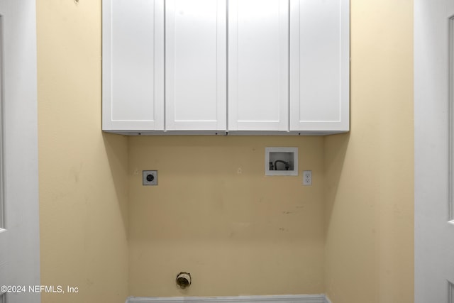 laundry area with hookup for an electric dryer, cabinets, and hookup for a washing machine