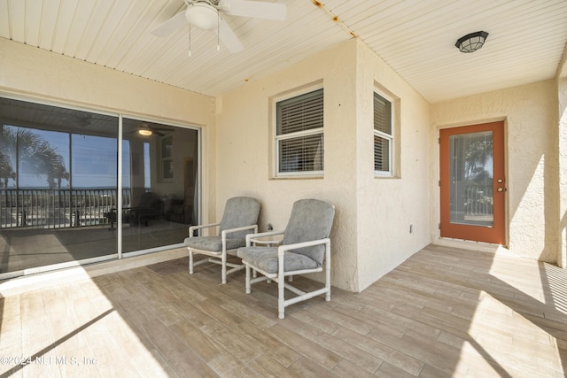 wooden deck featuring ceiling fan