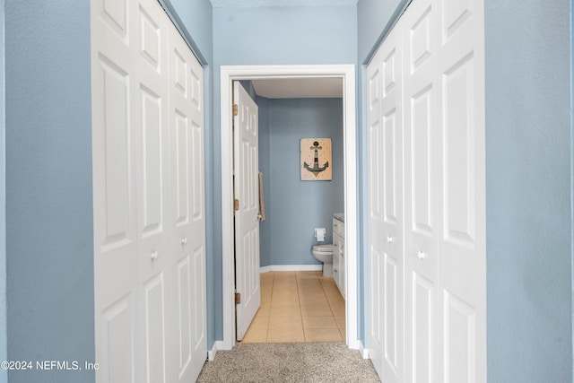 hallway featuring light tile patterned flooring