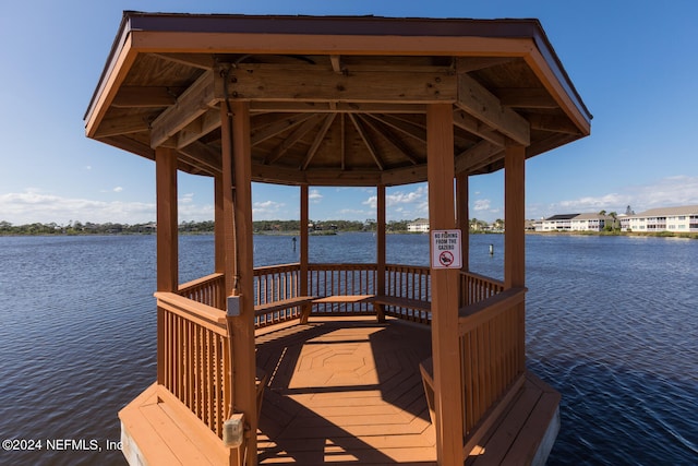 view of dock featuring a gazebo and a water view