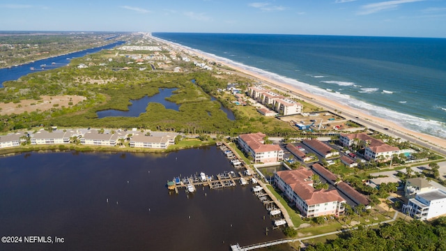 birds eye view of property with a water view and a view of the beach