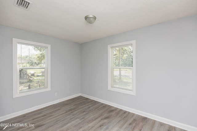 spare room with hardwood / wood-style floors