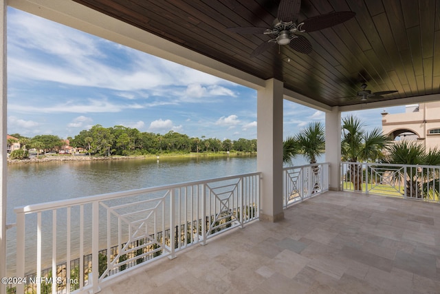 view of patio / terrace with a water view and a ceiling fan