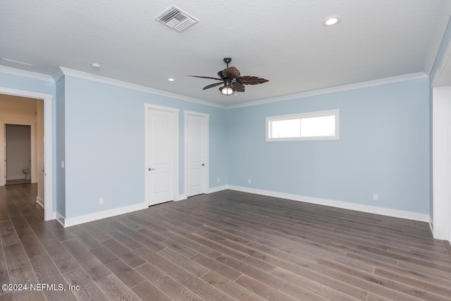 unfurnished room with dark wood-style floors, ornamental molding, visible vents, and baseboards