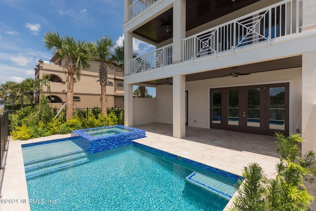 outdoor pool with a ceiling fan, a patio area, fence, and an in ground hot tub