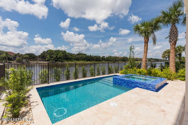 view of swimming pool featuring a patio, a water view, fence, and a pool with connected hot tub