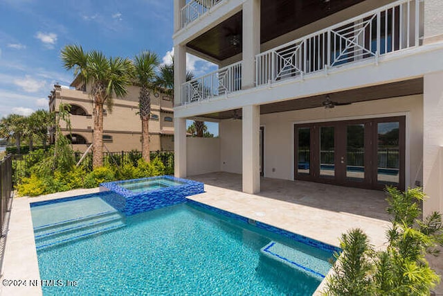 view of swimming pool featuring a ceiling fan, a pool with connected hot tub, a patio, and fence