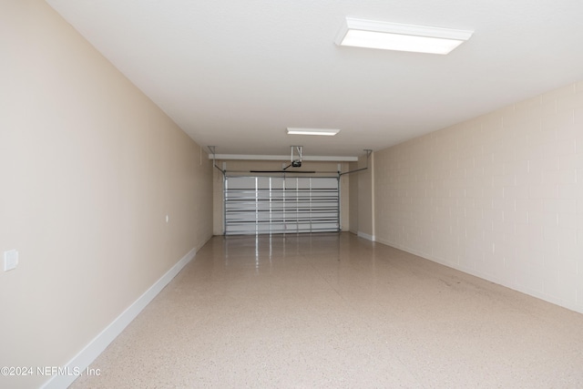 garage with a garage door opener and baseboards