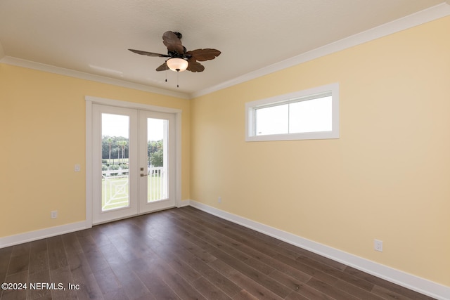 spare room featuring baseboards, ceiling fan, dark wood-style flooring, and crown molding