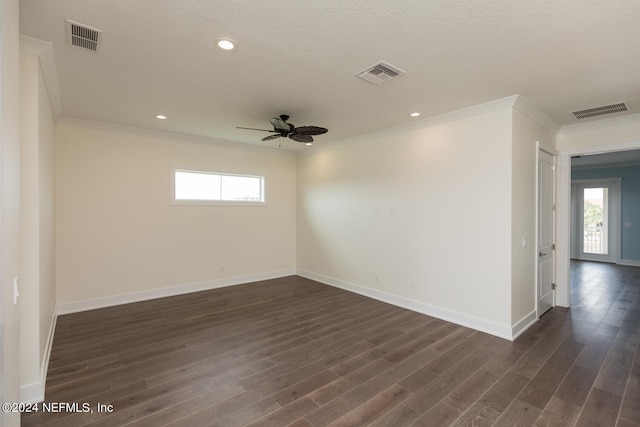 spare room with ornamental molding, dark wood-style flooring, and visible vents