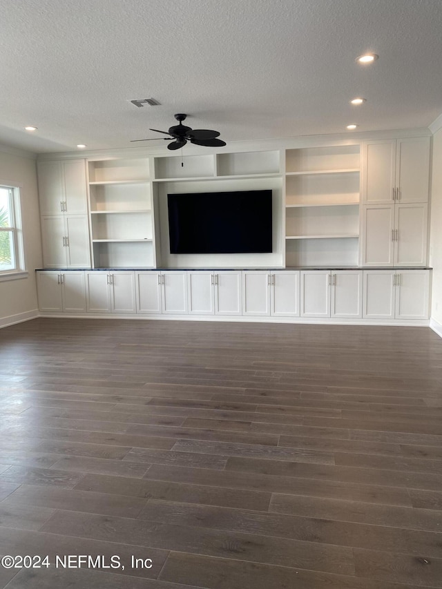 unfurnished living room with a textured ceiling, recessed lighting, visible vents, a ceiling fan, and dark wood finished floors