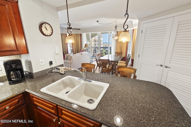 kitchen featuring sink, ceiling fan, and decorative light fixtures