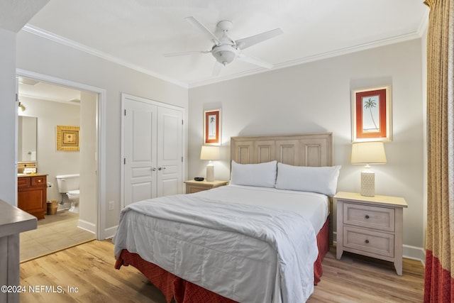 bedroom featuring crown molding, a closet, and light wood-type flooring