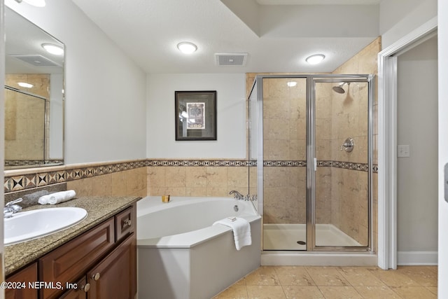 bathroom featuring vanity, tile patterned flooring, and shower with separate bathtub