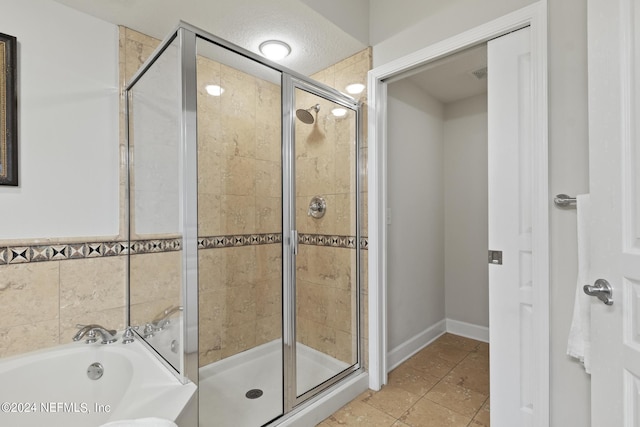 bathroom featuring separate shower and tub