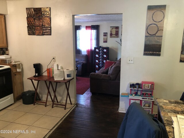 living room with a textured ceiling and hardwood / wood-style floors