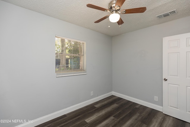 spare room with dark wood-type flooring, ceiling fan, and a textured ceiling