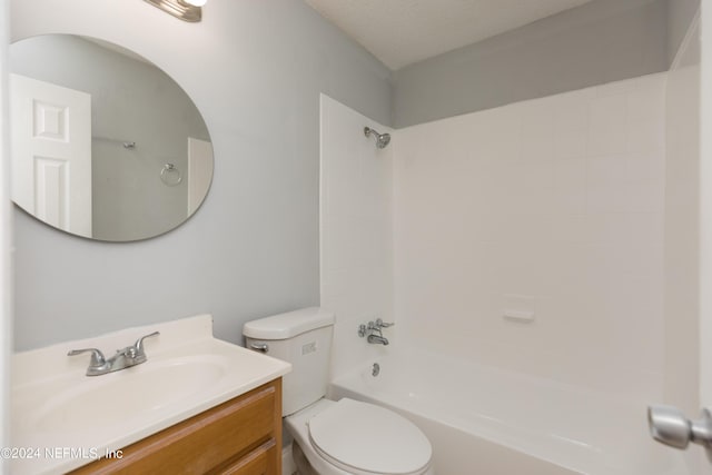 full bathroom with vanity, a textured ceiling,  shower combination, and toilet