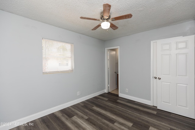 unfurnished bedroom featuring dark wood-type flooring, ceiling fan, and a textured ceiling