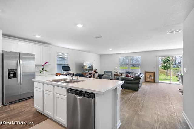 2035 Garrison Way, Green Cove Springs, FL 32043 - kitchen featuring sink, appliances with stainless steel finishes, white cabinetry, light hardwood / wood-style floors, and an island with sink